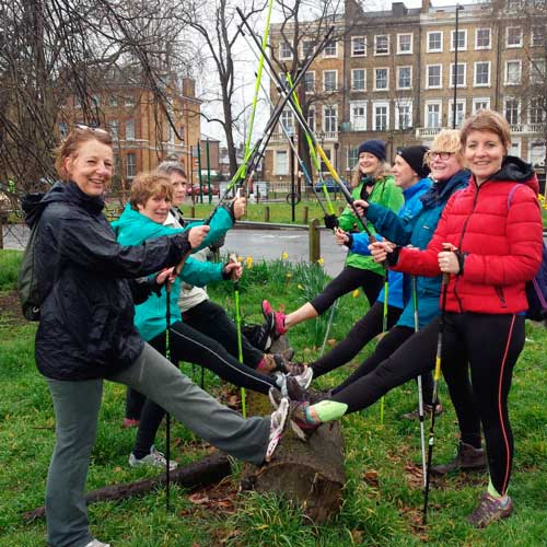 A Nordic walking beginners course warm up on Clapham Common with walking poles
